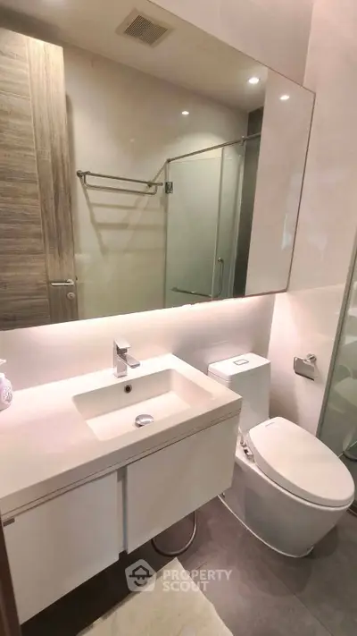Modern bathroom with sleek fixtures and glass shower enclosure