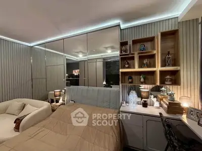 Luxurious bedroom with modern decor, mirrored wardrobe, and ambient lighting