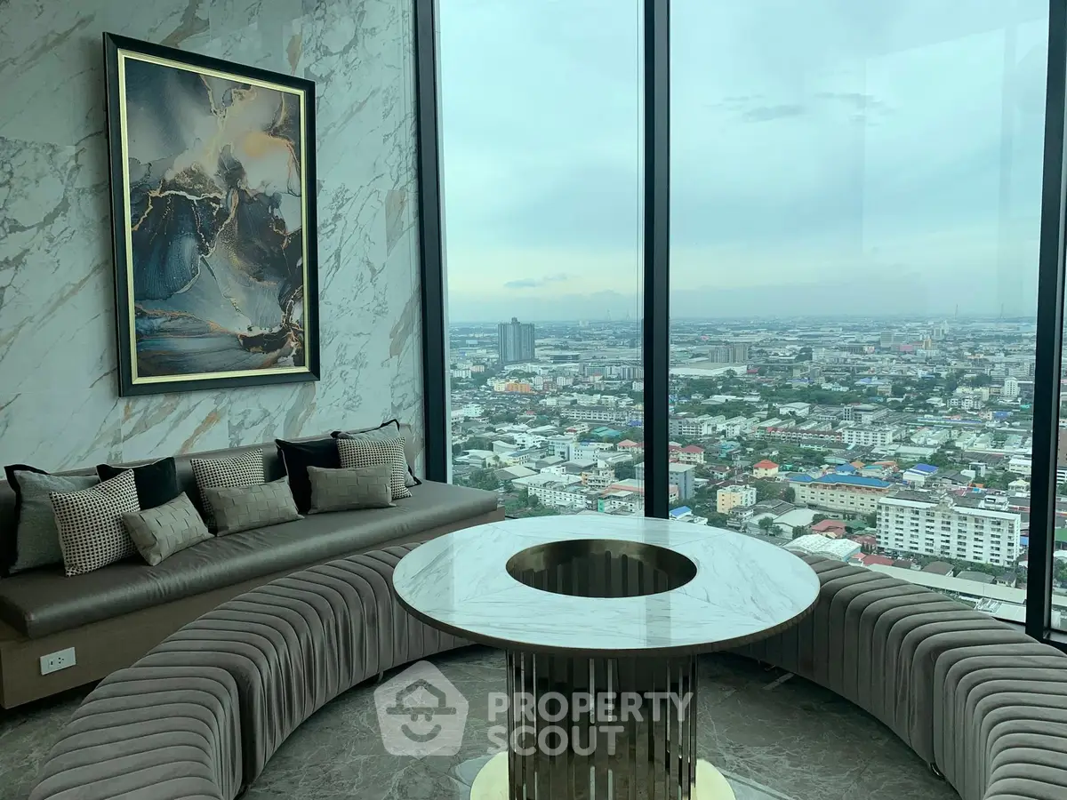 Luxurious high-rise living room with panoramic city view and elegant marble decor.