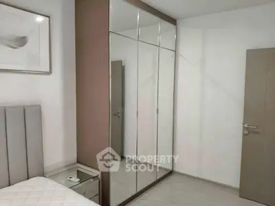 Modern bedroom with mirrored wardrobe and stylish decor