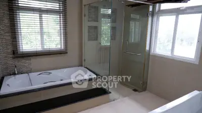 Luxurious bathroom with bathtub and glass shower enclosure