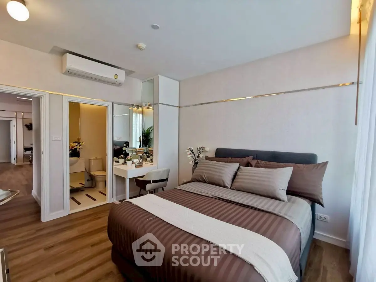 Luxurious bedroom with elegant decor and modern amenities in a stylish apartment.