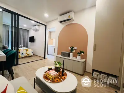 Modern living room with stylish decor and open layout, featuring air conditioning and cozy ambiance.