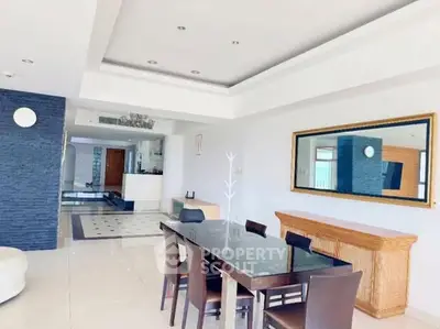 Spacious modern dining area with elegant decor and ample natural light.