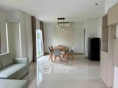 Spacious modern living room with dining area and sleek furniture