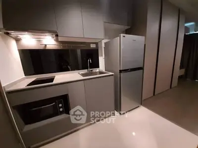 Modern compact kitchen with sleek cabinetry and stainless steel appliances