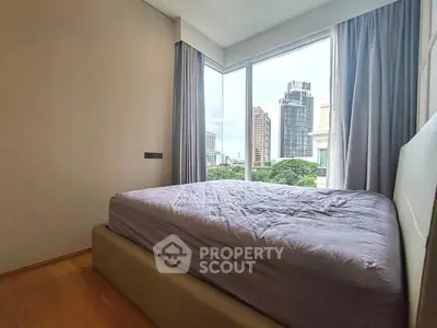 Modern bedroom with large windows offering stunning city views