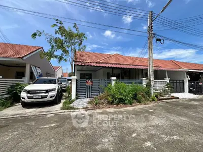 Charming single-story home with red-tiled roof and driveway in a serene neighborhood.