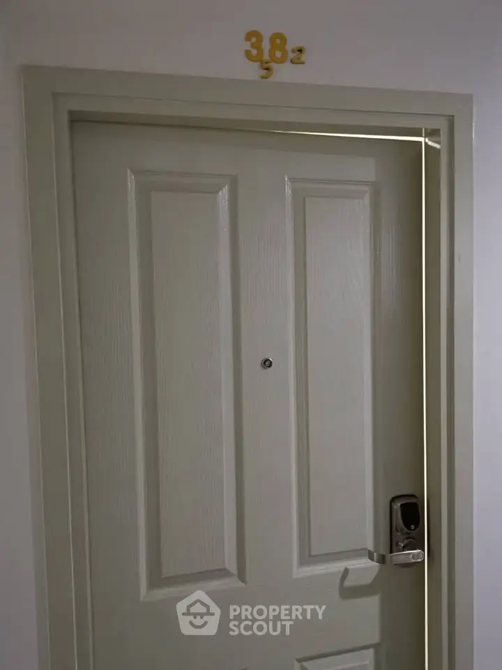 Modern apartment entrance with secure digital lock and room number 382.