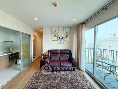 Modern living room with balcony view, featuring cozy seating and stylish decor in a high-rise apartment.