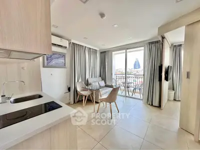 Modern open-plan living room with kitchen and balcony view in a stylish apartment.