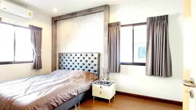 Modern bedroom with stylish headboard and ample natural light
