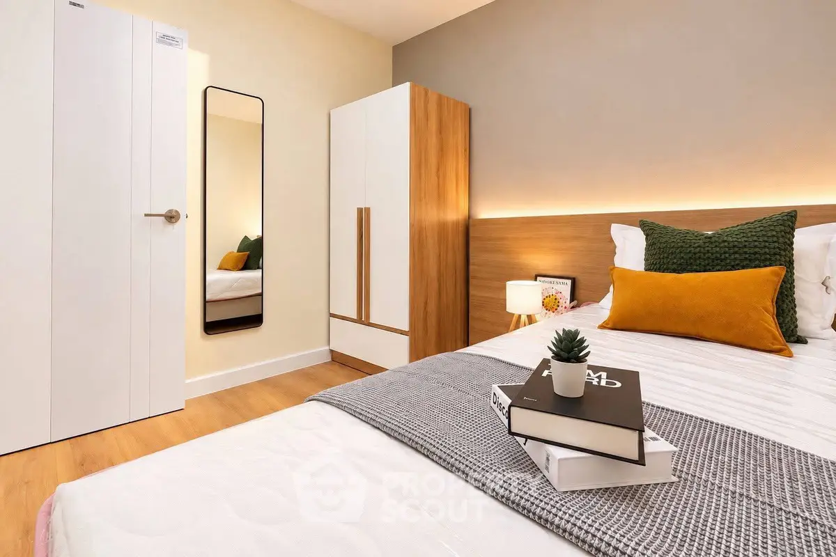 Modern bedroom with stylish decor and cozy ambiance, featuring a comfortable bed and sleek wardrobe.