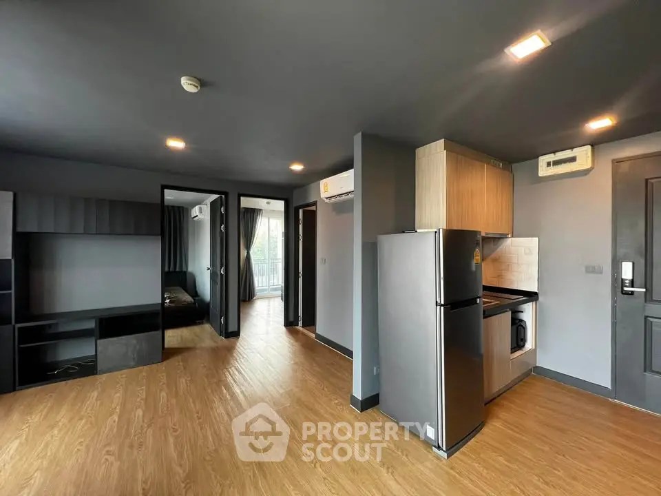 Modern apartment interior with open kitchen and wooden flooring
