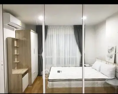 Modern bedroom with minimalist design, featuring a cozy bed, wooden furniture, and large window with curtains.