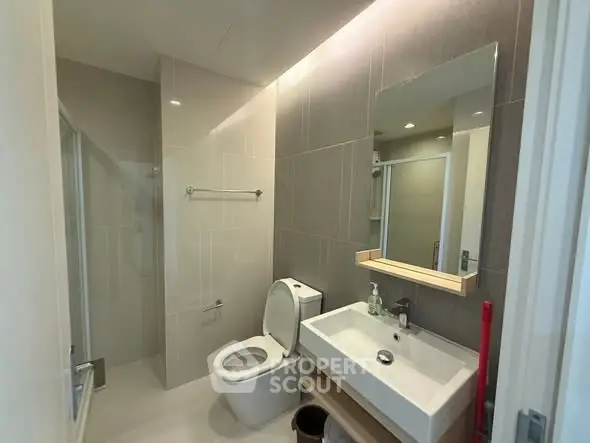 Modern bathroom with sleek fixtures and spacious shower area.