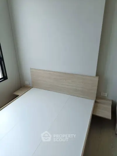 Modern minimalist bedroom with wooden bed frame and side tables