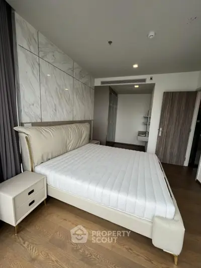 Luxurious modern bedroom with elegant marble wall and stylish furnishings