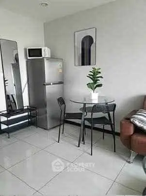 Modern apartment interior with dining area and stainless steel fridge