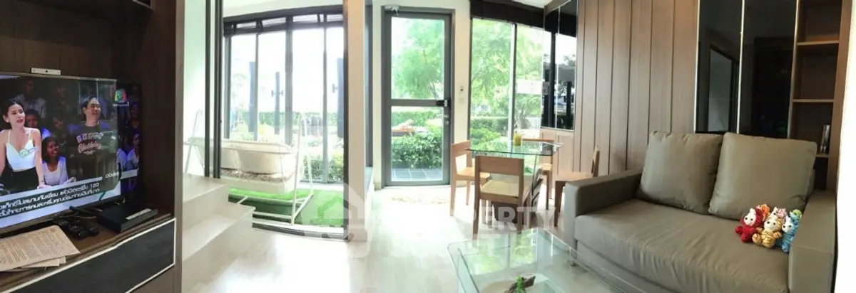 Spacious living room with modern decor and garden view, perfect for relaxation.
