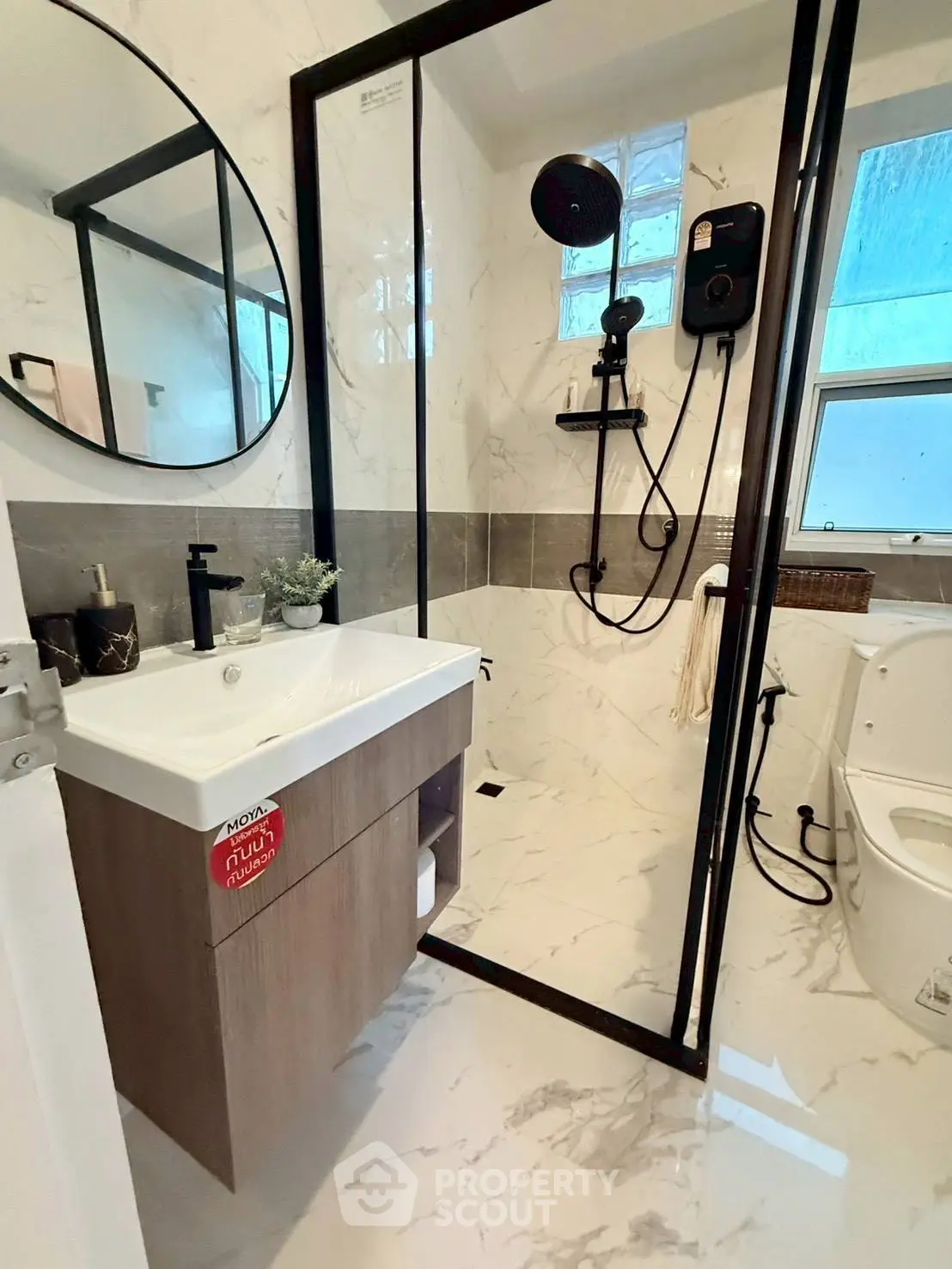 Modern bathroom with sleek shower and elegant marble tiles