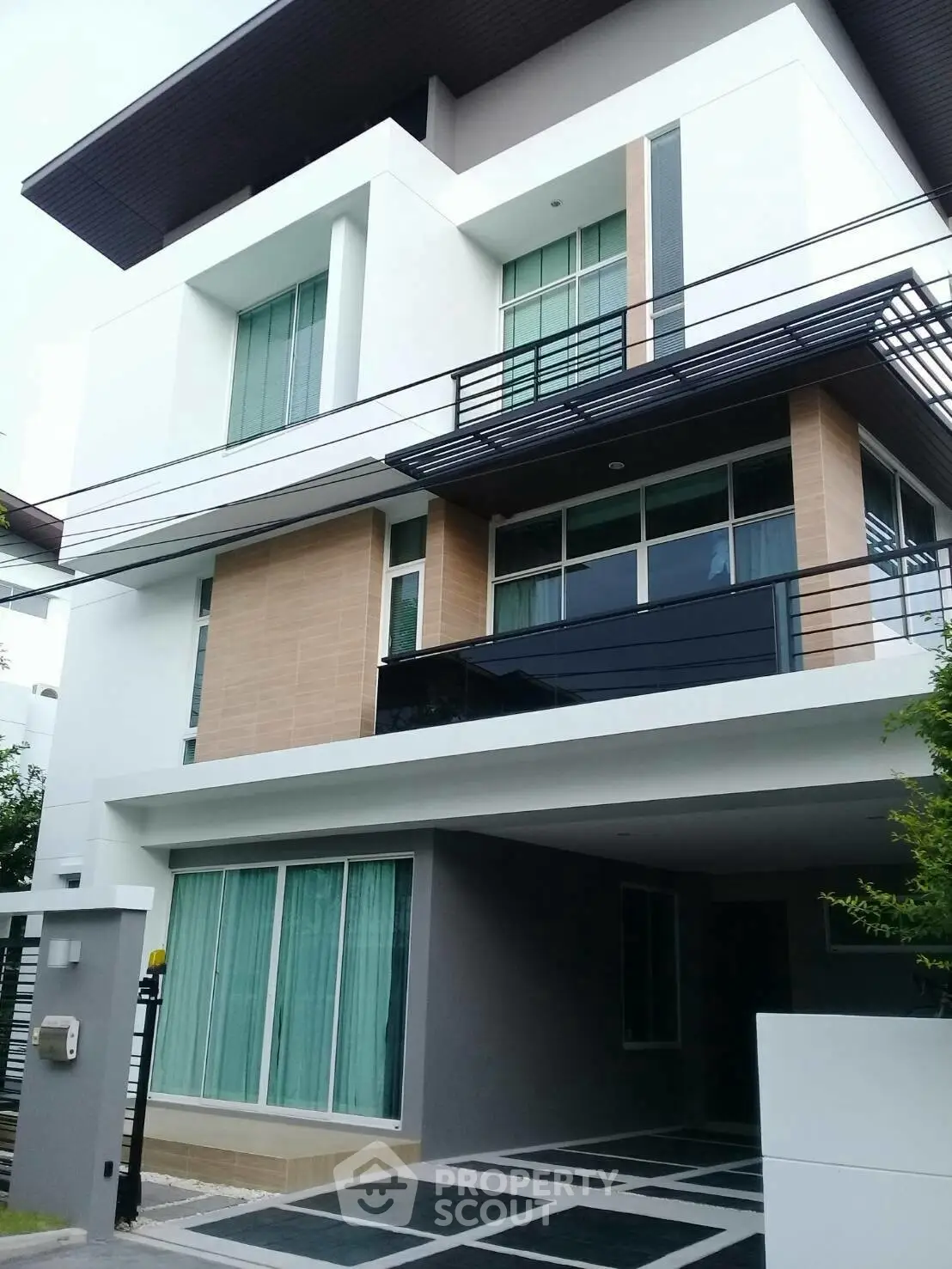Modern three-story house with sleek design and large windows