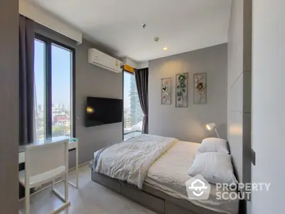 Modern bedroom with city view, featuring sleek decor and natural light.