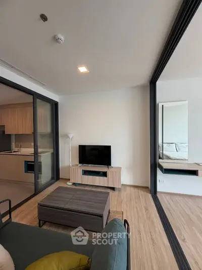 Modern living room with open layout and sleek kitchen design