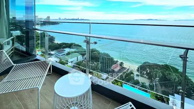 Stunning ocean view from modern balcony with sleek furniture, perfect for relaxation and enjoying the scenery.