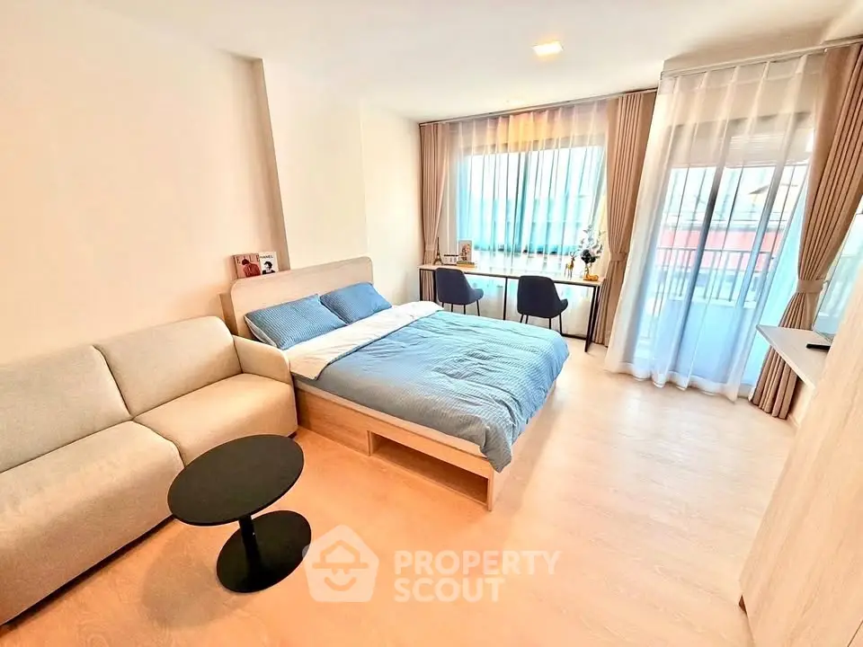 Spacious modern bedroom with natural light and stylish decor