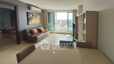 Spacious modern living room with city view, stylish furniture, and ample natural light.