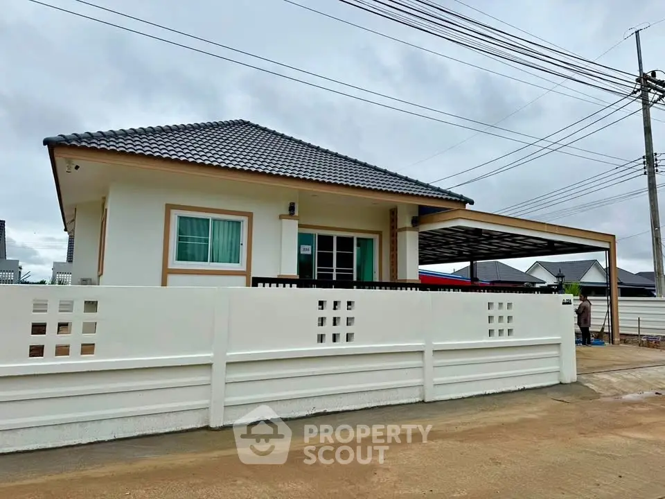 Charming single-story house with modern design and spacious carport in a serene neighborhood.