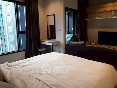 Modern bedroom with large window and stylish decor in urban apartment