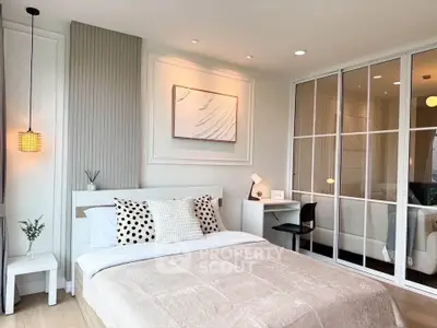 Modern bedroom with stylish decor and mirrored closet doors
