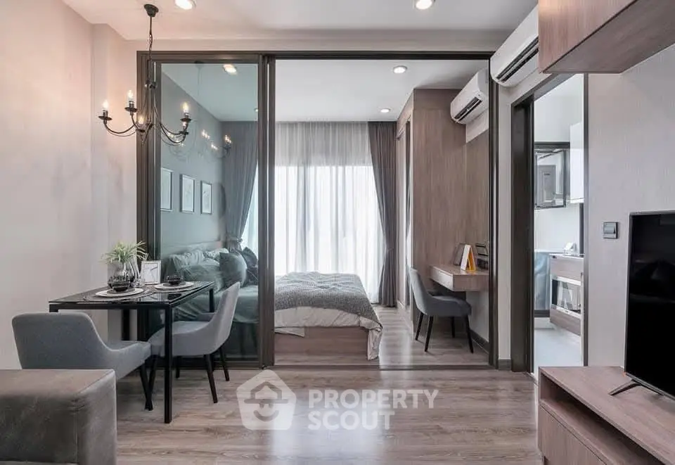 Modern open-plan apartment with stylish living area and cozy bedroom, featuring elegant decor and natural light.