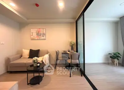 Modern living room with cozy seating and dining area in open layout apartment.