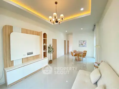 Elegant living room with modern chandelier and cozy seating area