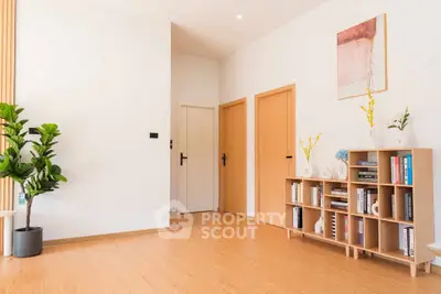 Modern minimalist living room with wooden flooring and stylish bookshelf