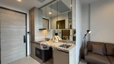Modern kitchen with sleek cabinetry and built-in appliances in a stylish apartment.