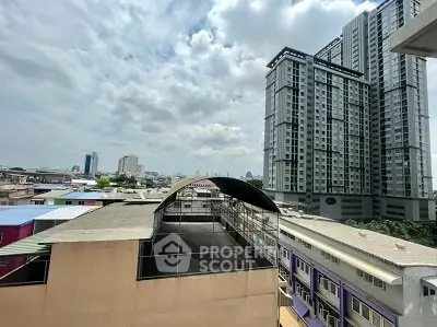 Stunning cityscape view from high-rise building balcony with modern architecture.