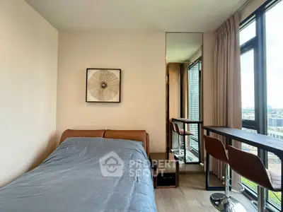 Modern bedroom with stylish decor and city view from large window