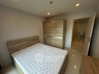 Modern bedroom with wooden furniture and white tiled flooring
