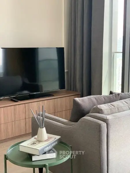 Modern living room with sleek TV setup and cozy gray sofa, perfect for relaxation.