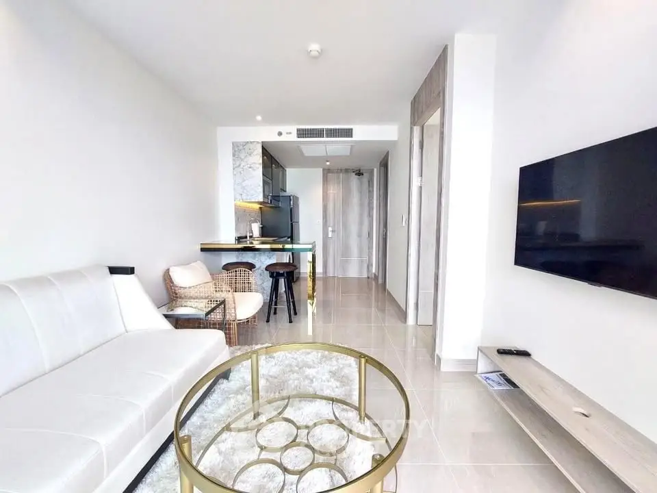 Modern living room with sleek furniture and open kitchen layout