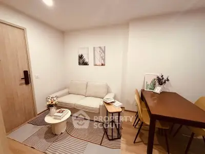 Cozy living room with modern decor and dining area, perfect for relaxation and entertaining.