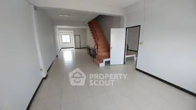 Spacious open-plan living area with staircase, ideal for modern living.