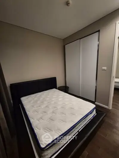 Modern bedroom with sleek design and comfortable mattress in stylish apartment.
