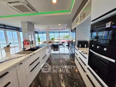 Luxurious modern kitchen with stunning ocean view and sleek appliances