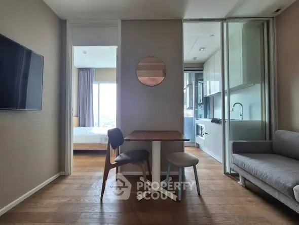 Modern apartment interior with open kitchen, dining area, and cozy living space.