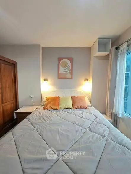 Cozy bedroom with modern decor and large window for natural light